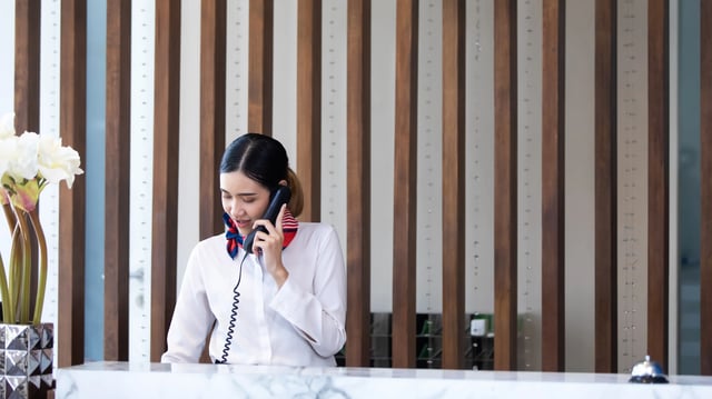 receptionist using voice communication system